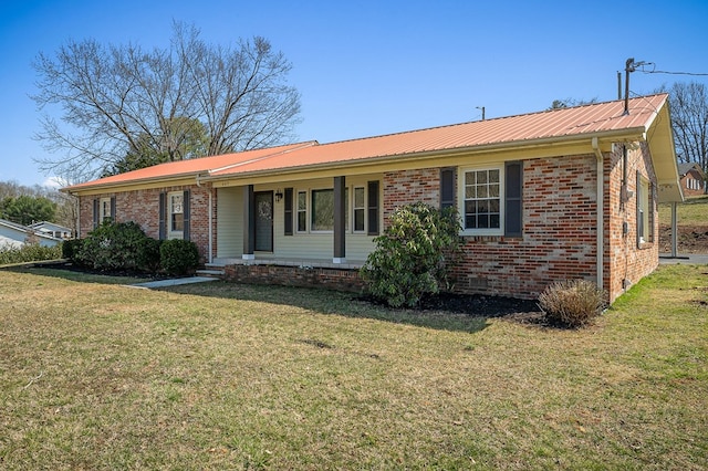 ranch-style home with crawl space, brick siding, metal roof, and a front lawn