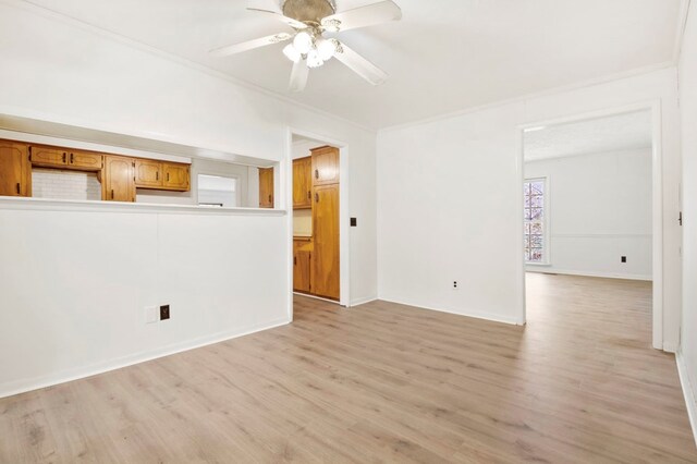 unfurnished living room featuring light wood-style flooring, ceiling fan, and crown molding