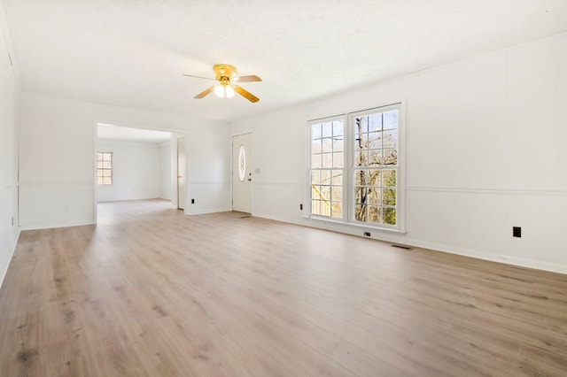 unfurnished room featuring visible vents, ceiling fan, light wood-style flooring, and a textured ceiling