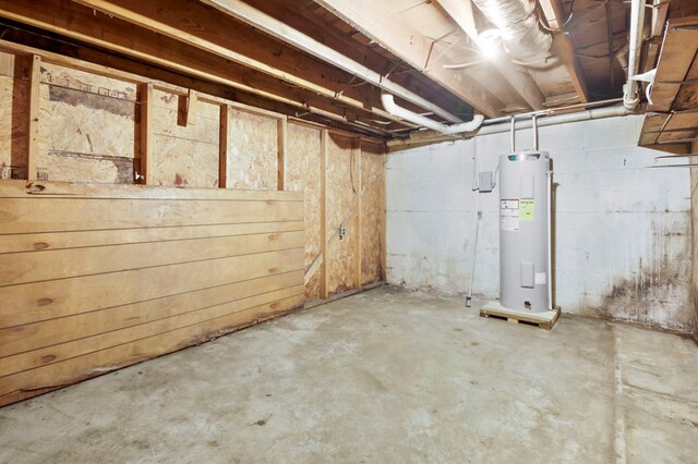 unfinished basement with electric water heater