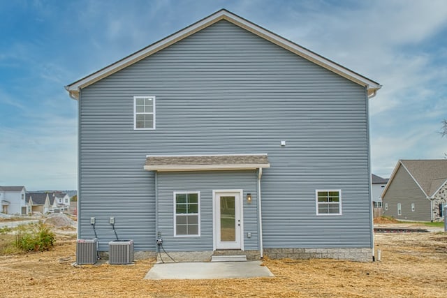 rear view of property featuring a patio area and cooling unit