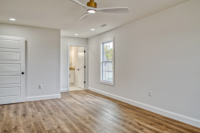 unfurnished bedroom with ensuite bathroom, recessed lighting, visible vents, baseboards, and light wood finished floors