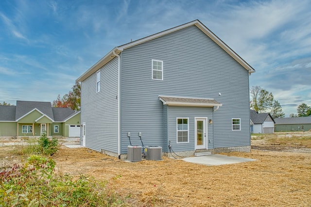 rear view of property with a patio and central air condition unit