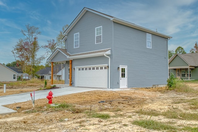 view of property exterior with a garage and driveway