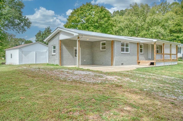 rear view of house with crawl space, a yard, a porch, and brick siding