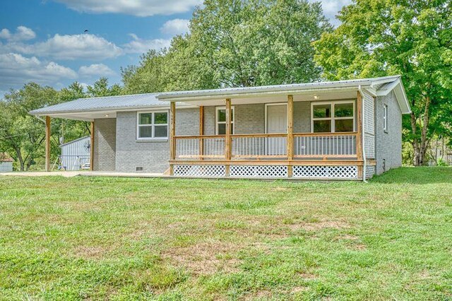 ranch-style house with crawl space, a front yard, a carport, and brick siding