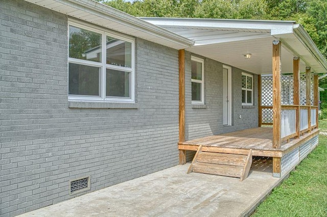 wooden terrace with a patio area and visible vents