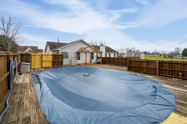 exterior space featuring a residential view, fence, and a wooden deck