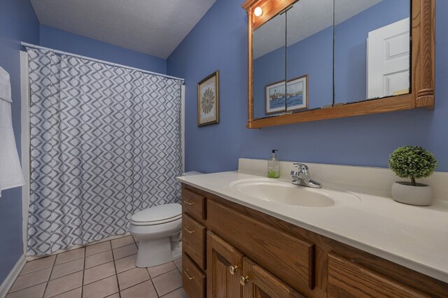 bathroom featuring a textured ceiling, toilet, tile patterned flooring, and vanity