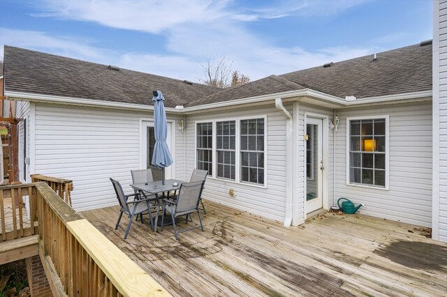 wooden deck featuring outdoor dining area