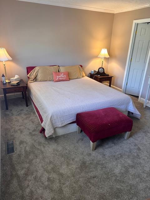 bedroom featuring light carpet, ornamental molding, and a closet