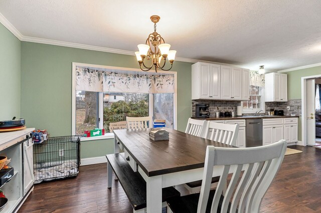 dining room featuring a healthy amount of sunlight, dark wood-style floors, a chandelier, and crown molding