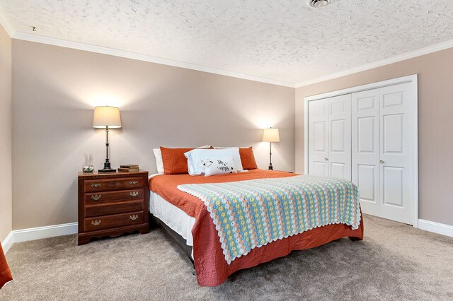 bedroom featuring ornamental molding, light colored carpet, built in desk, and a textured ceiling