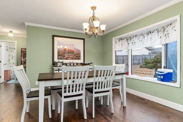 dining space with dark wood-style floors, crown molding, visible vents, an inviting chandelier, and baseboards