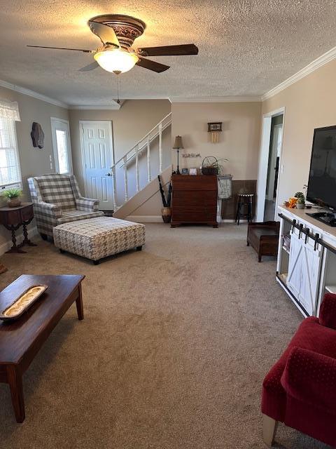 bedroom with ceiling fan, a textured ceiling, crown molding, and light colored carpet