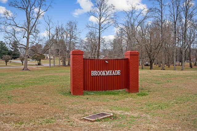 community / neighborhood sign with a lawn