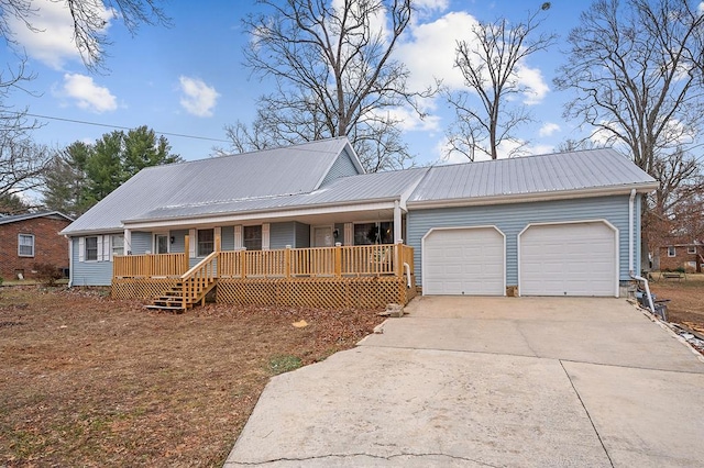 single story home featuring a garage, covered porch, metal roof, and concrete driveway