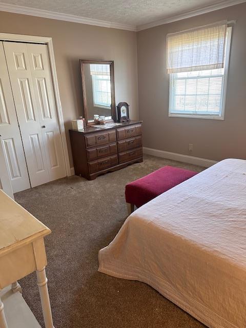 bathroom with a sink, a textured ceiling, baseboards, and double vanity