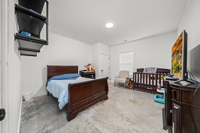 bedroom featuring multiple windows, visible vents, and baseboards