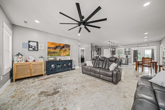 living room with recessed lighting, visible vents, and baseboards