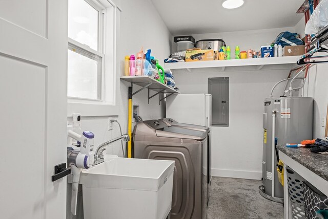 laundry room with laundry area, electric panel, washer and clothes dryer, water heater, and a sink