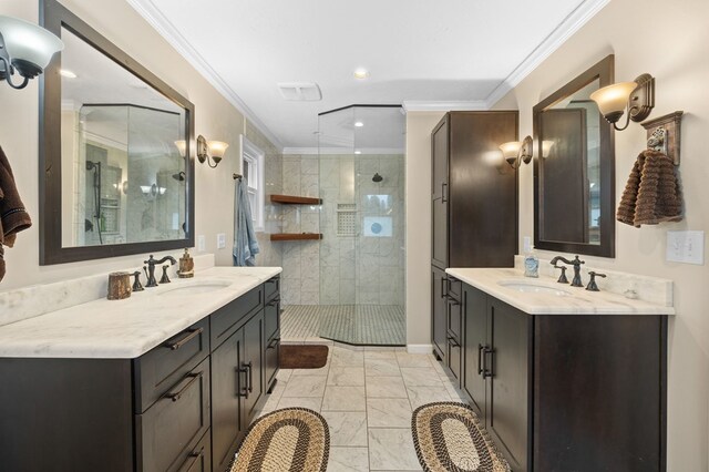 full bathroom featuring ornamental molding, a stall shower, marble finish floor, and a sink