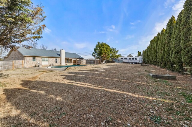 view of yard featuring a patio, a fenced backyard, and a fenced in pool