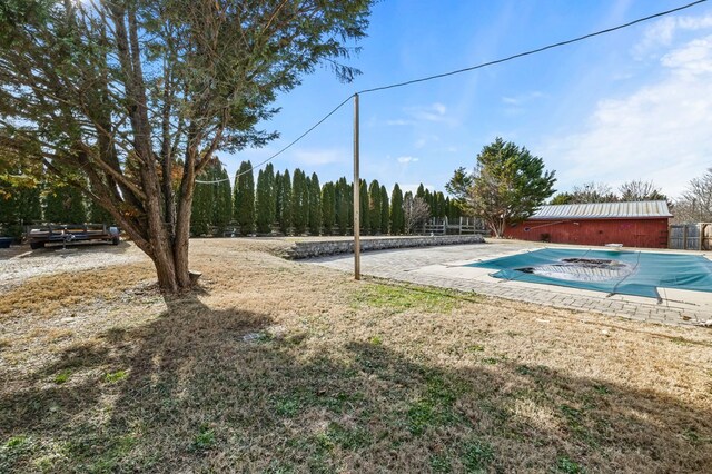 view of pool featuring a covered pool and fence