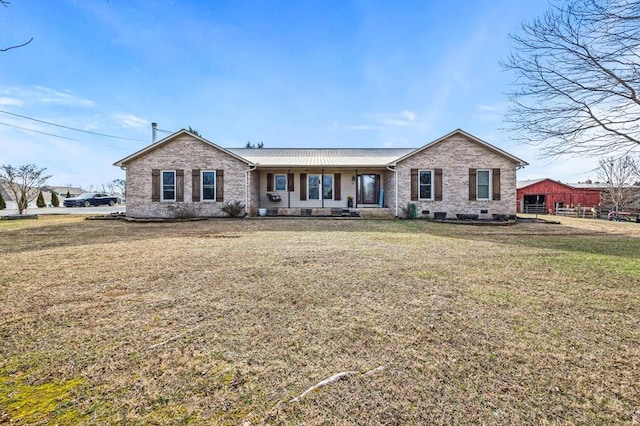 single story home with brick siding, a porch, a front yard, crawl space, and metal roof