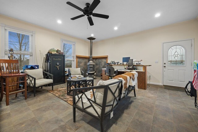 living area with a wood stove, baseboards, ornamental molding, and recessed lighting