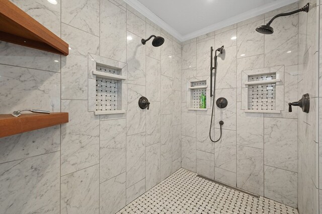 bathroom with ornamental molding and tiled shower