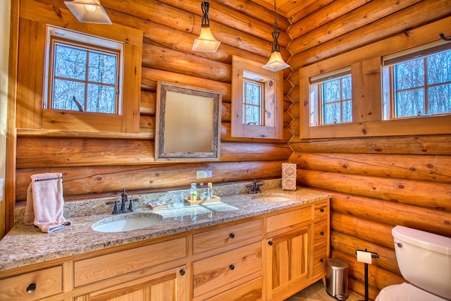 bathroom featuring a sink and log walls