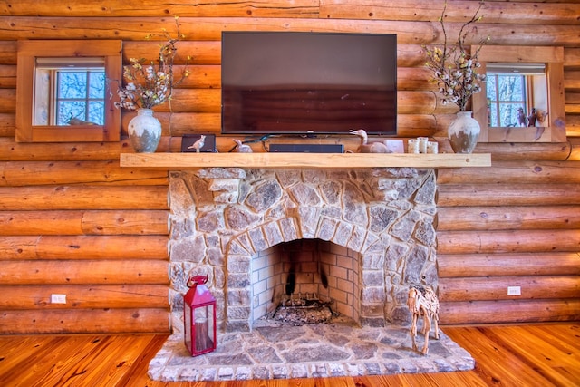 interior details with a fireplace and wood finished floors