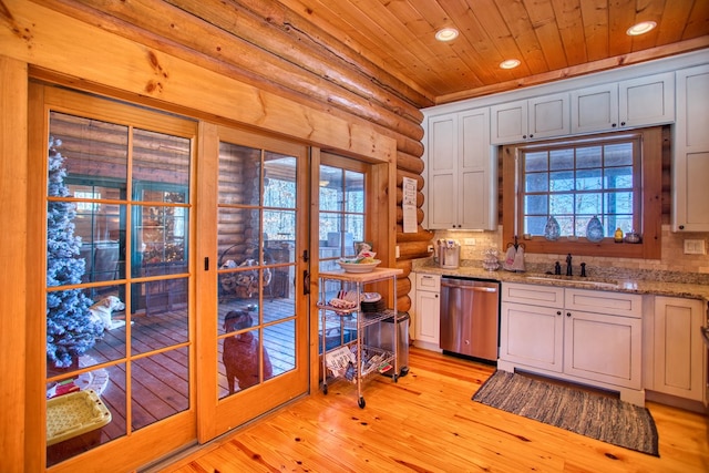 kitchen with recessed lighting, a sink, wood ceiling, stainless steel dishwasher, and a wealth of natural light