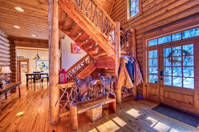 entrance foyer featuring hardwood / wood-style flooring, recessed lighting, wood ceiling, stairway, and a wealth of natural light