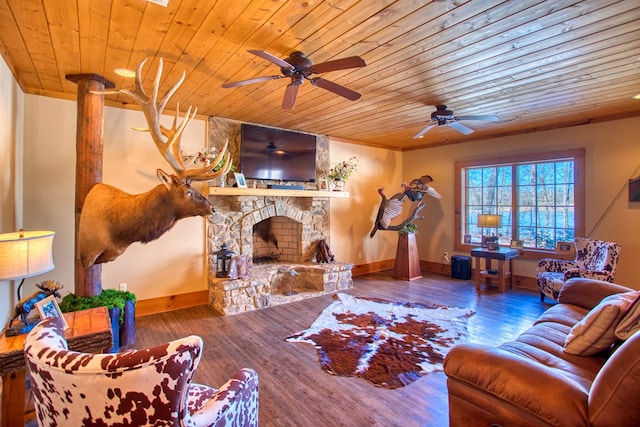 living area featuring wood ceiling, a fireplace, baseboards, and wood finished floors