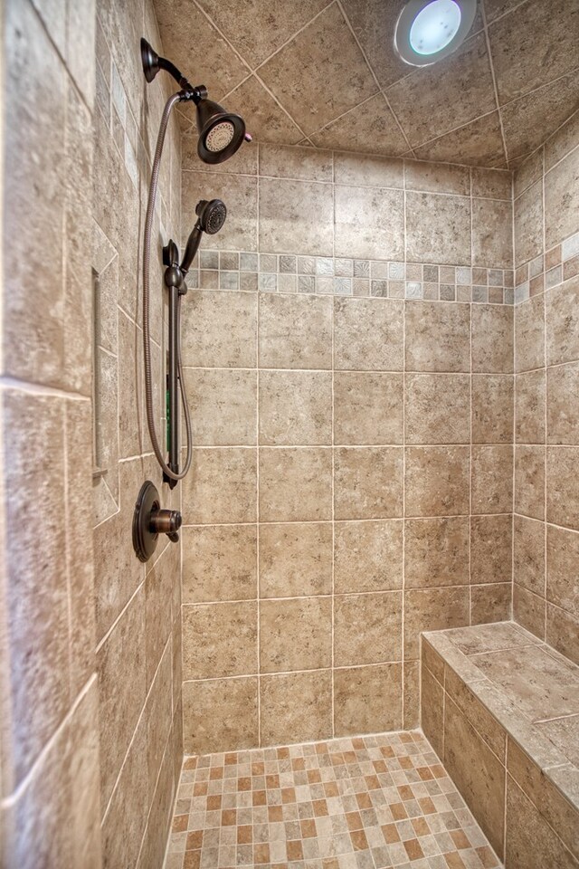 full bath with a tile shower