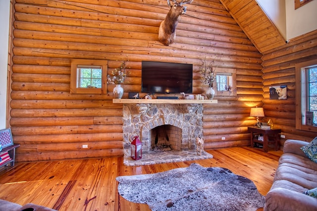 living room with a fireplace, high vaulted ceiling, and hardwood / wood-style floors