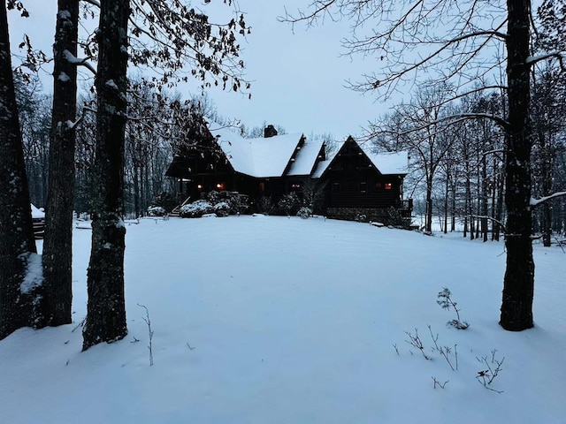 snowy yard featuring a garage