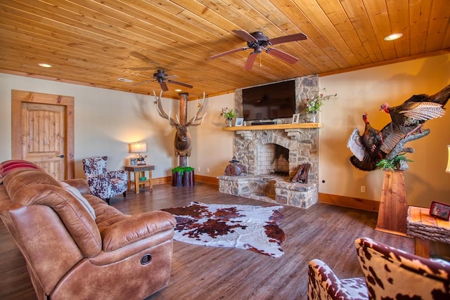 living area featuring wooden ceiling, a fireplace, baseboards, and wood finished floors