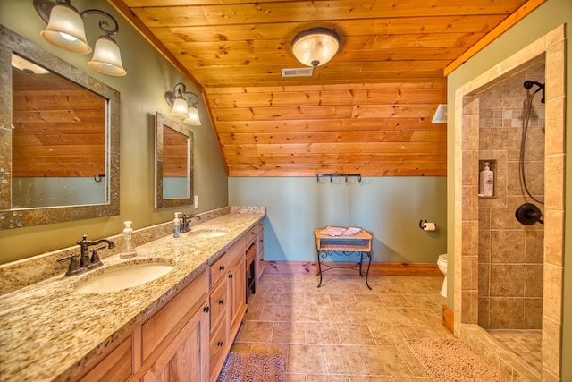 bathroom featuring wooden ceiling, visible vents, a sink, and tiled shower