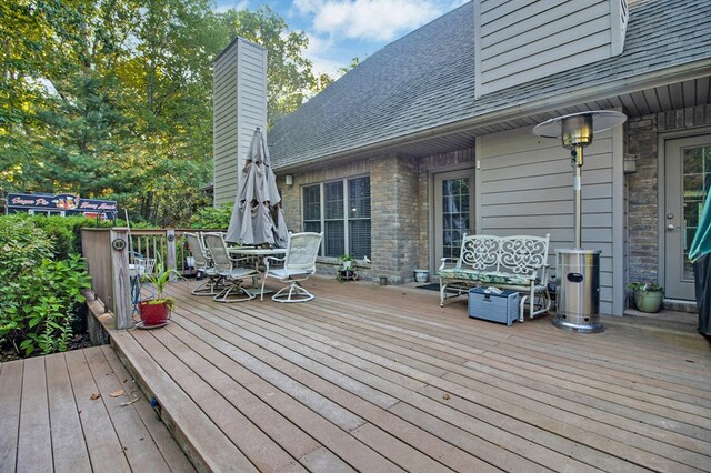 wooden terrace with outdoor dining space