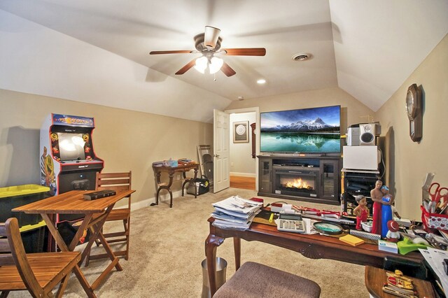 living area with lofted ceiling, light colored carpet, visible vents, a ceiling fan, and a warm lit fireplace