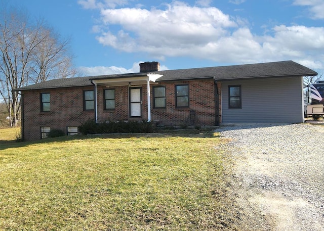 single story home featuring driveway, a chimney, a front lawn, and brick siding