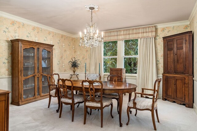 dining room with light carpet, wallpapered walls, ornamental molding, and a chandelier