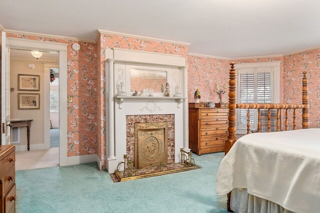 bedroom featuring wallpapered walls, carpet, a fireplace, and crown molding