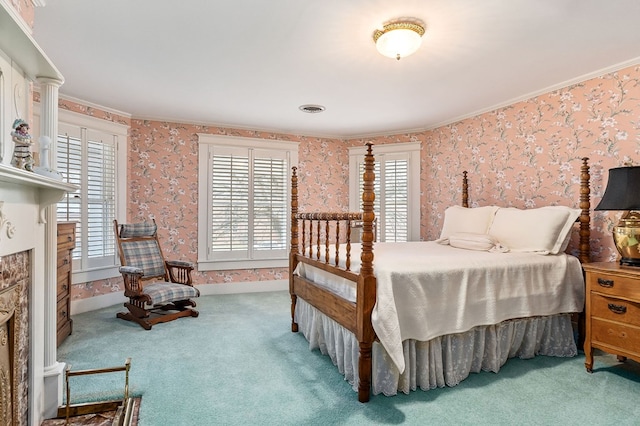 bedroom featuring wallpapered walls, multiple windows, visible vents, and a fireplace