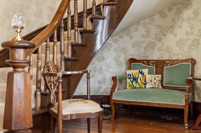 interior space with stairs, wood finished floors, wainscoting, and wallpapered walls