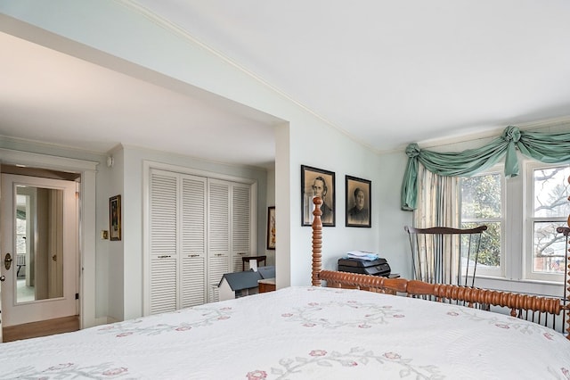 bedroom with a closet and crown molding