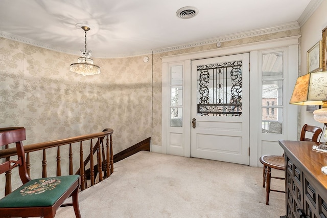 carpeted foyer featuring wallpapered walls, visible vents, and ornamental molding